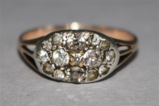 An early 20th century gold and diamond cluster dress ring, size Q.
